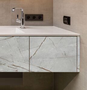 Integral countertop sink on wooden cabinets in contemporary bathroom